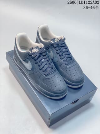 Pair of black Nike Air Force 1 sneakers displayed on a shoebox.