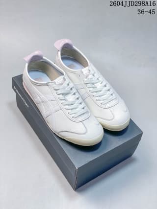 Pair of white low-top sneakers displayed on a dark shoe box, with light pink accents visible at the collars and heels.