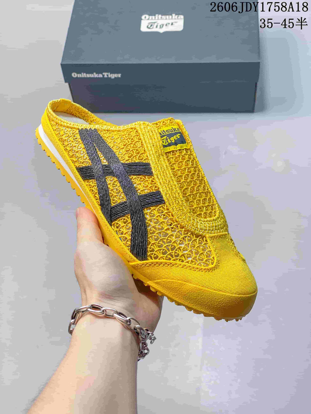 Angled view of the yellow Onitsuka Tiger Mexico 66 Sabot sneaker with dark side stripes