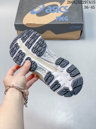 View of the sneaker outsole showing segmented black and gray rubber traction sections and a light-colored midsole.