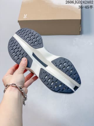 Bottom view of the ON Cloudboom Max shoe showing the segmented dark outsole and white midsole.