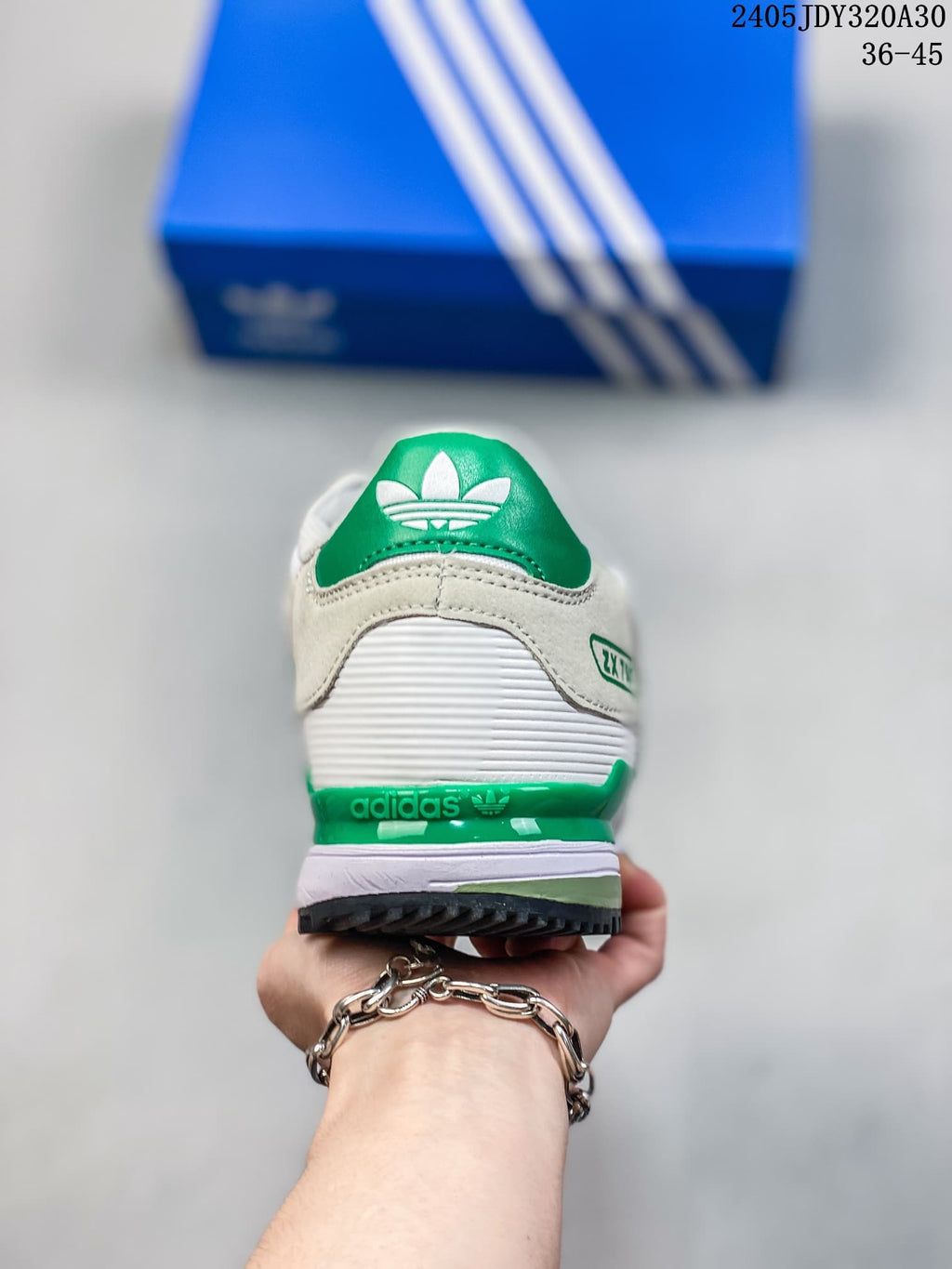 Rear view of a white and green Adidas ZX 750 sneaker