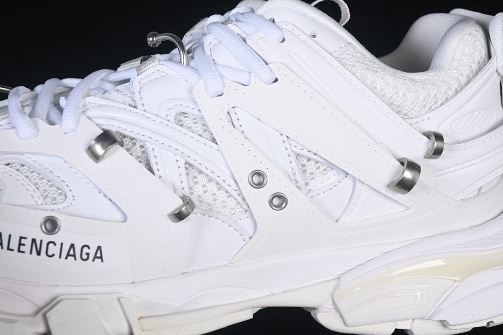 Close-up of the layered side panels, mesh sections, laces, and metal-tone details.
