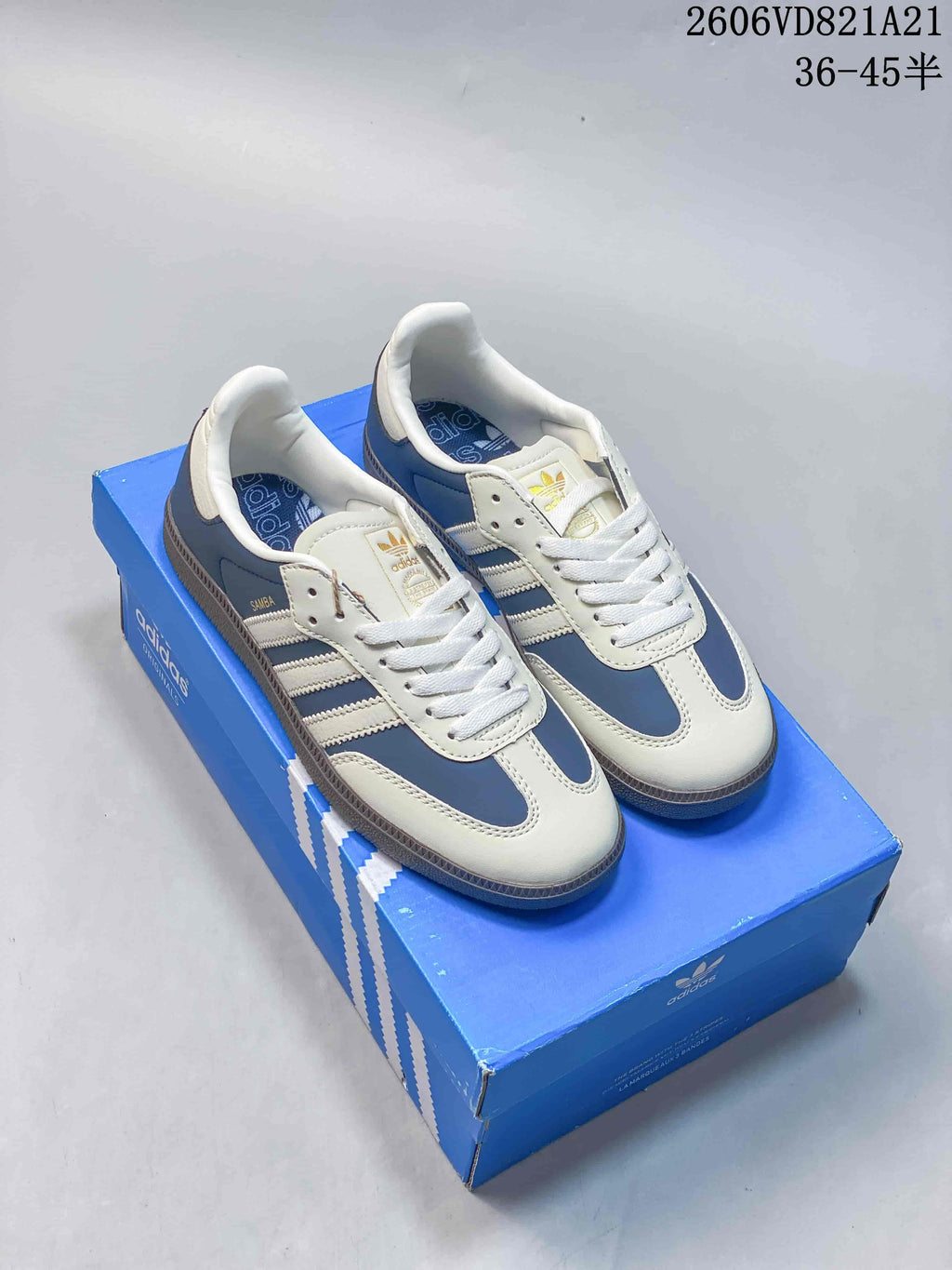 Blue and white adidas Samba low-top sneakers displayed on a blue shoe box