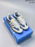 Blue and white adidas Samba low-top sneakers displayed on a blue shoe box