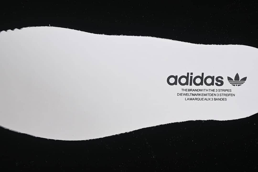 White shoe-shaped insert with adidas branding.