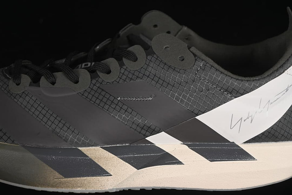 Close-up of the patterned upper, laces, side panels, and heel detail