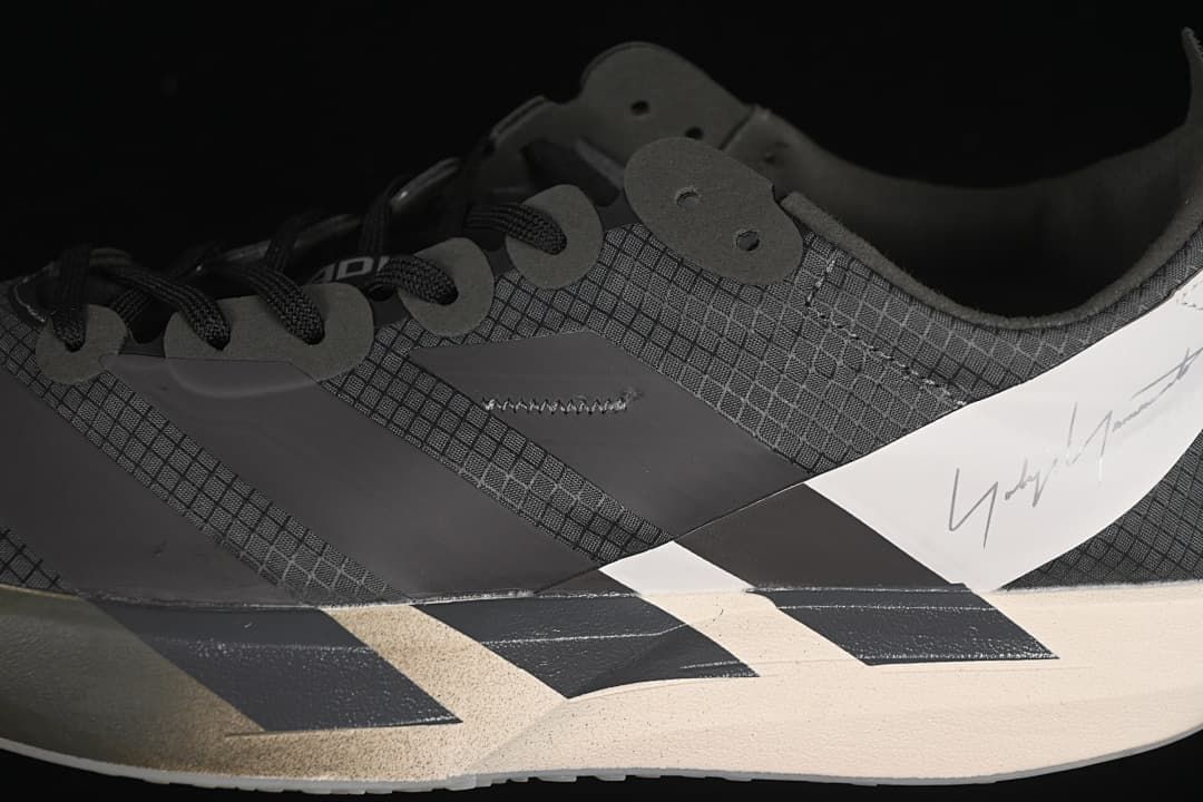 Close-up of the patterned upper, laces, side panels, and heel detail