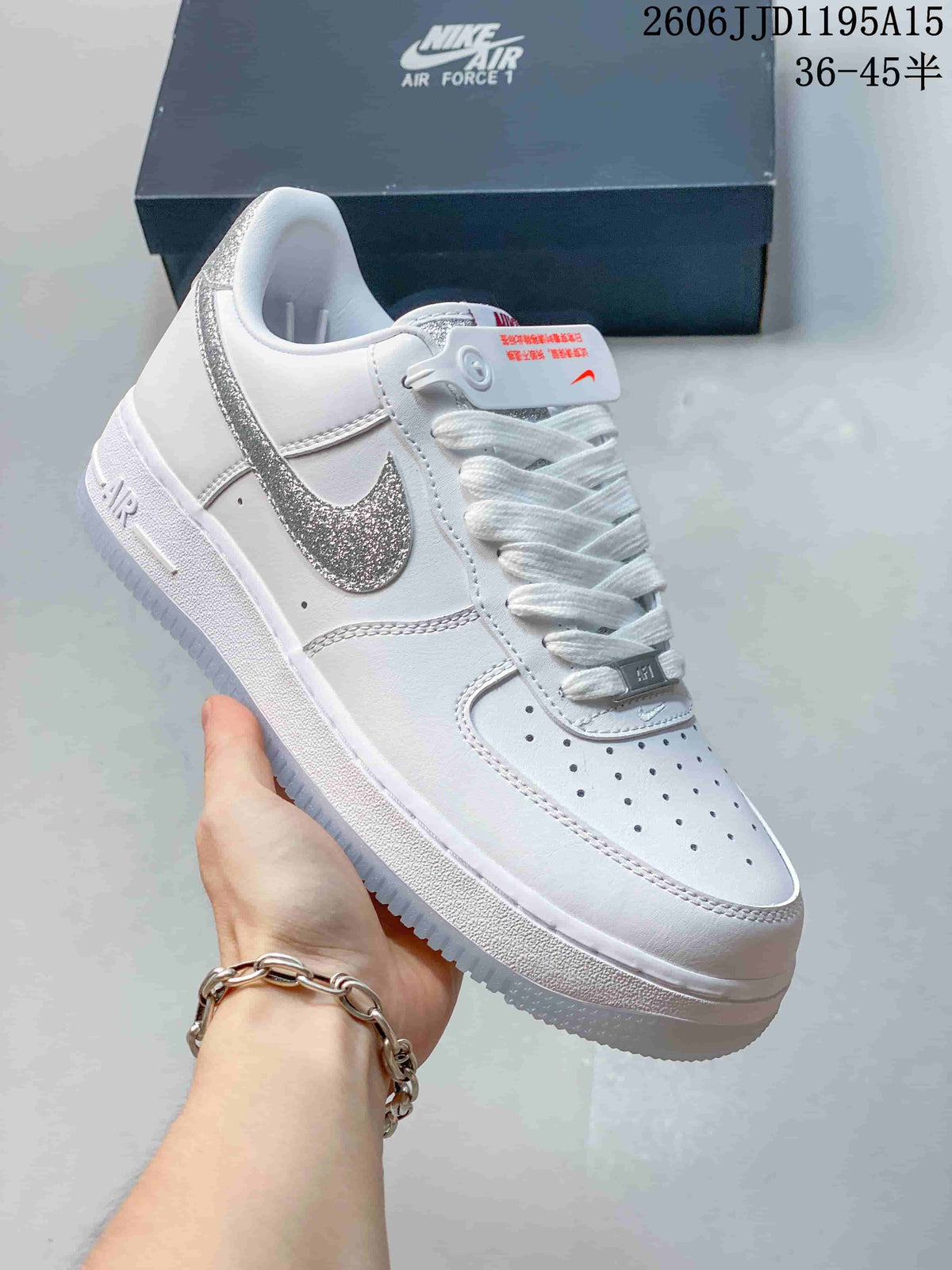 Side view of a white low-top sneaker with a silver reflective-look Swoosh and perforated toe.