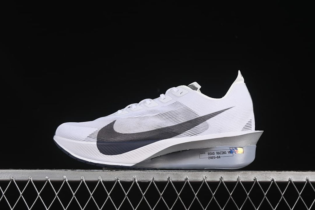 Side profile of the white road racing shoe with dark Swoosh and silver-toned midsole.