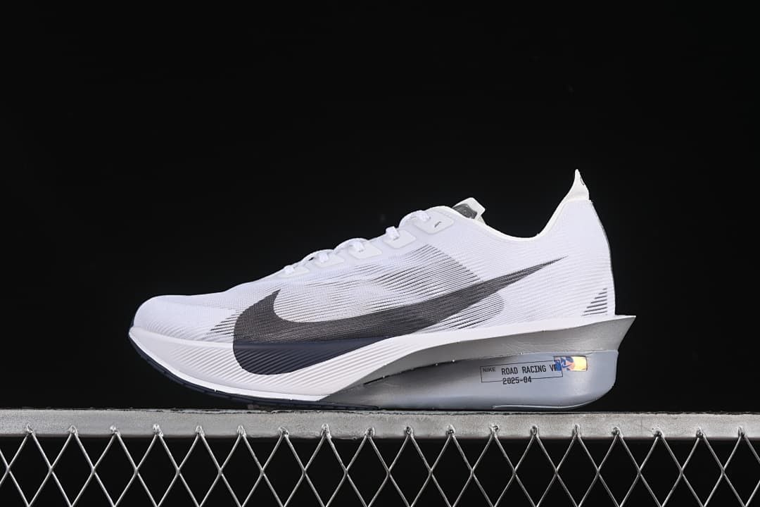 Side profile of the white road racing shoe with dark Swoosh and silver-toned midsole.