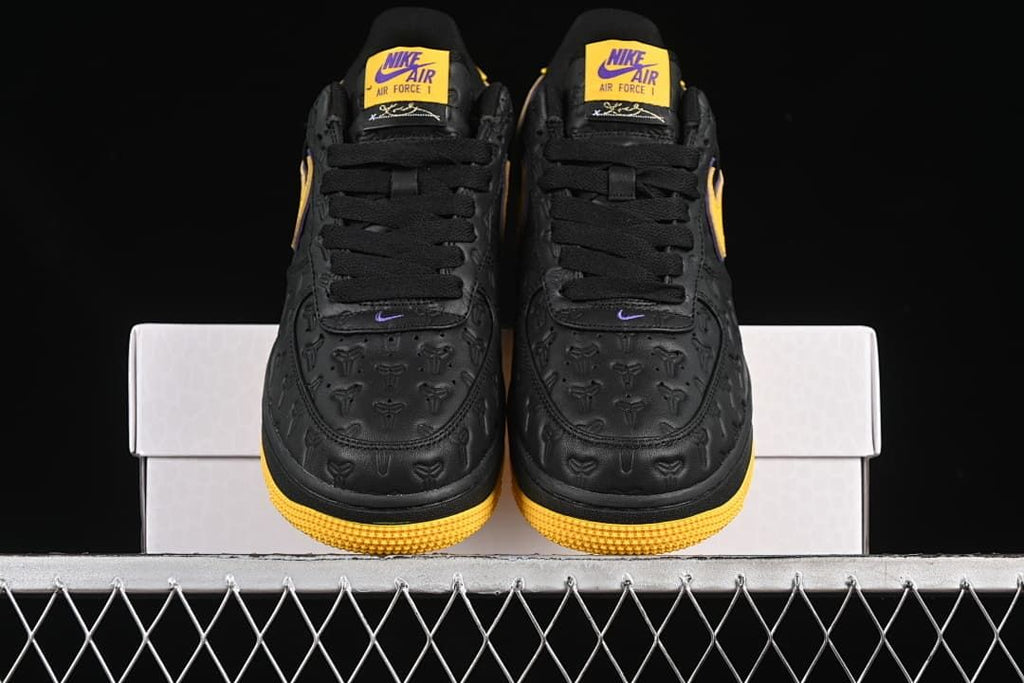 Front view of the pair showing embossed toe panels and yellow outsole edges.