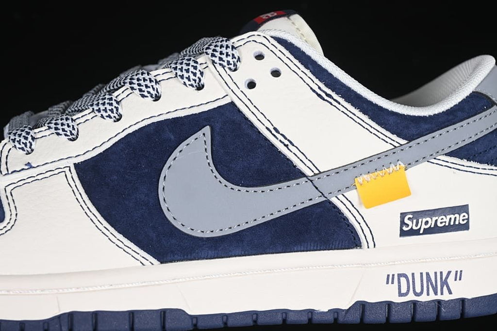 Side detail showing the gray Swoosh, navy panels, patterned laces, and Supreme branding.