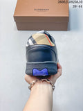 Rear view of a navy low-top sneaker with a beige check-pattern heel panel and textured outsole