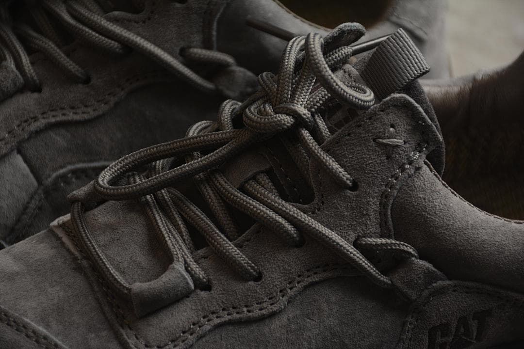 Close-up of the gray lace-up area, overlays and CAT side logo.