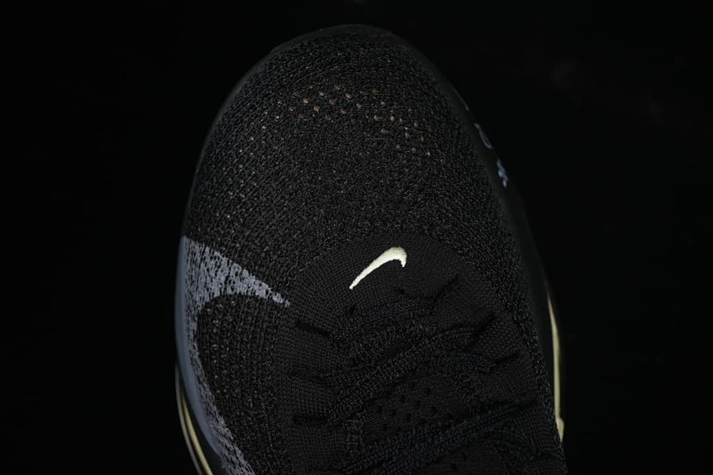Top view of the black knit-style toe and laces