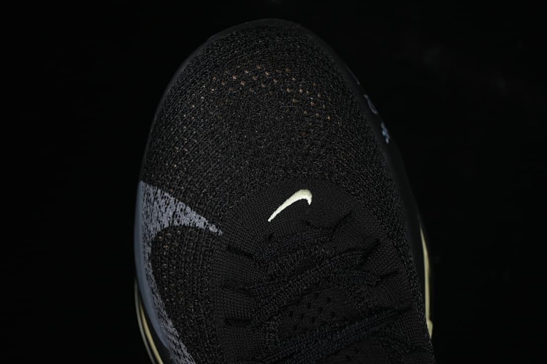 Top view of the black knit-style toe and laces