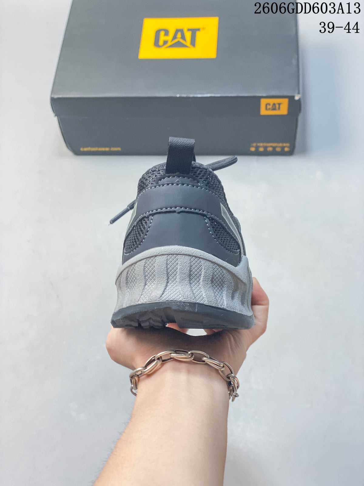 Rear view showing the sneaker's mesh heel, pull tab, and sculpted light-gray midsole
