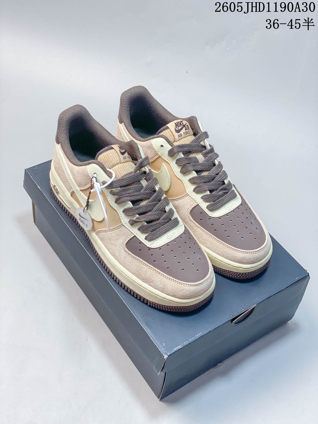 Pair of beige, cream, tan, and brown Nike Air Force 1 '07 LV8 low-top sneakers on a shoebox