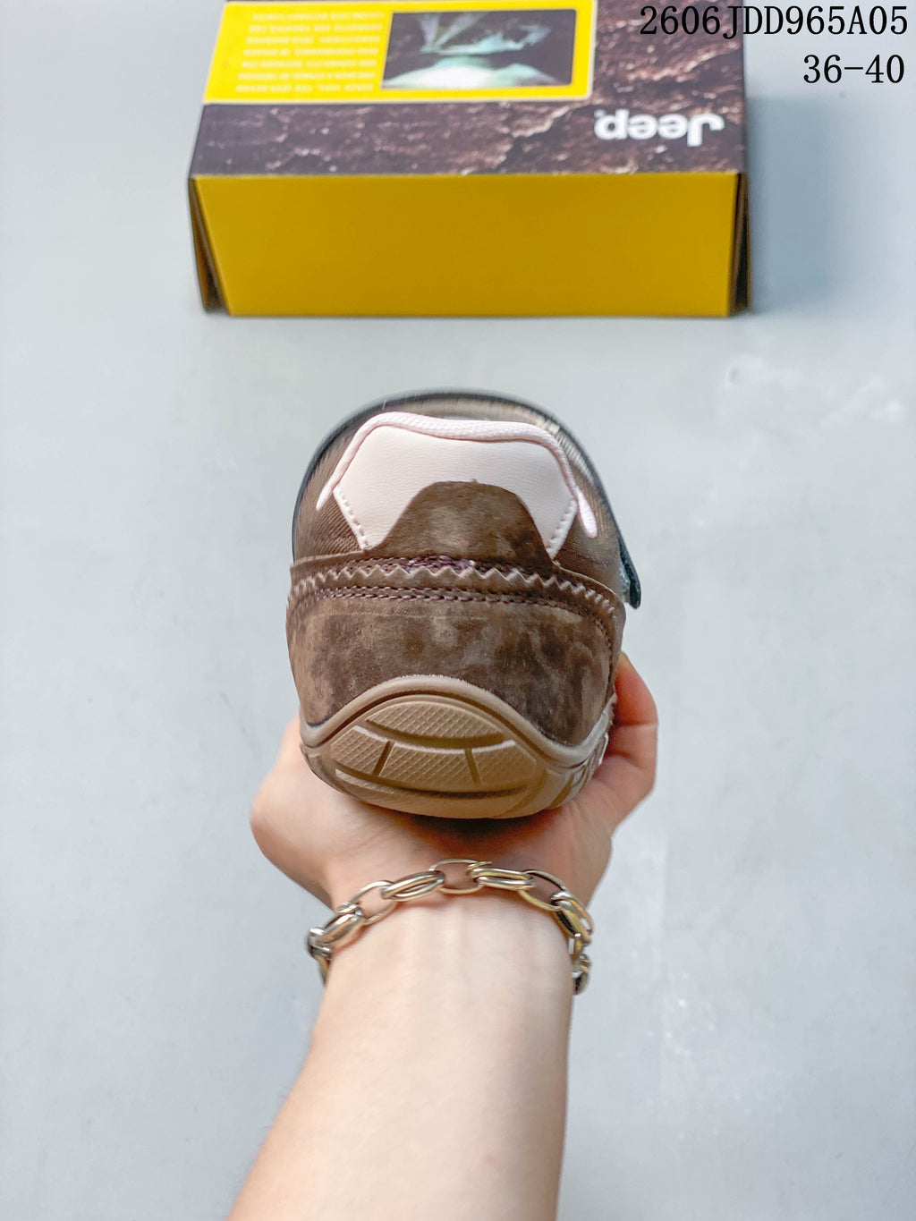 Rear view showing the heel, stitching and sole of the brown casual shoe