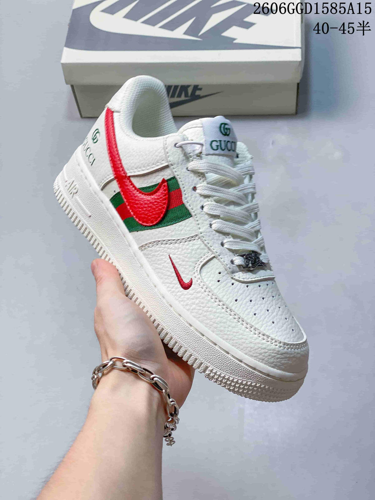 Close-up of a white low-top sneaker with red-and-green side panels and a red swoosh detail.
