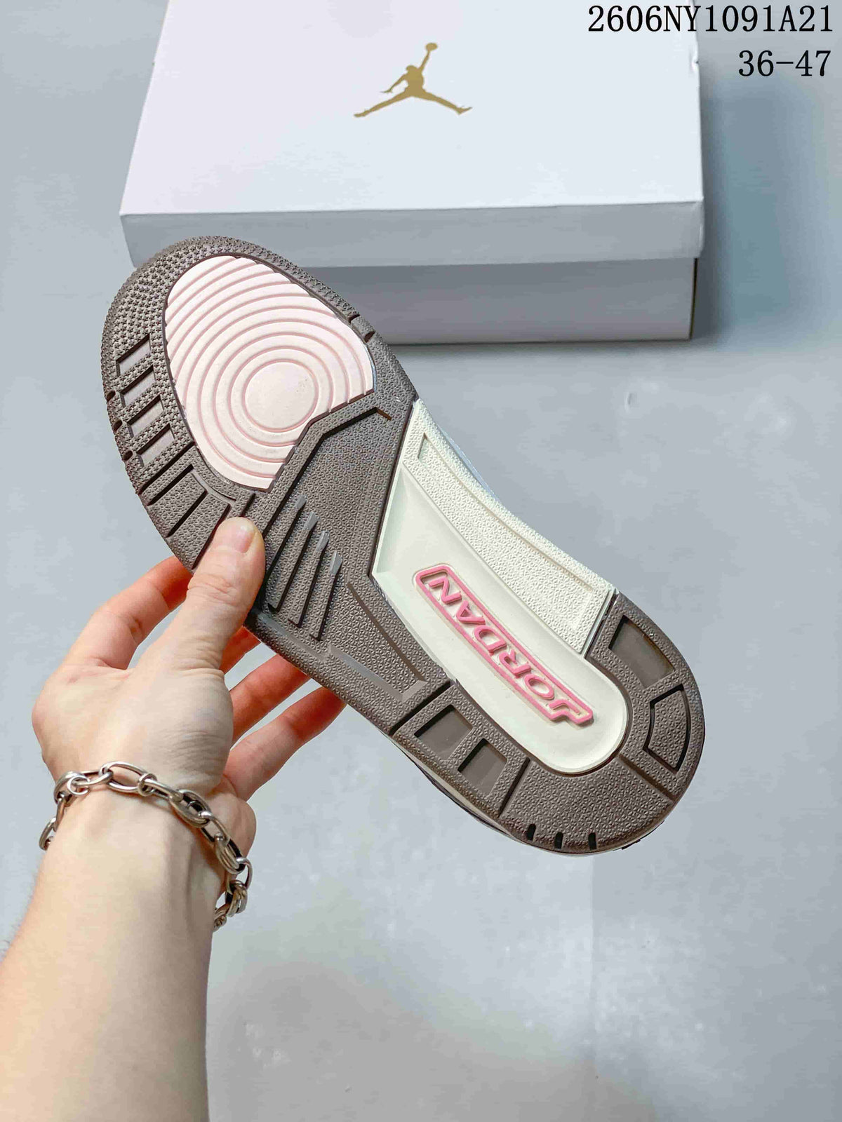 Outsole view of the sneaker showing a grey tread and pale pink circular section
