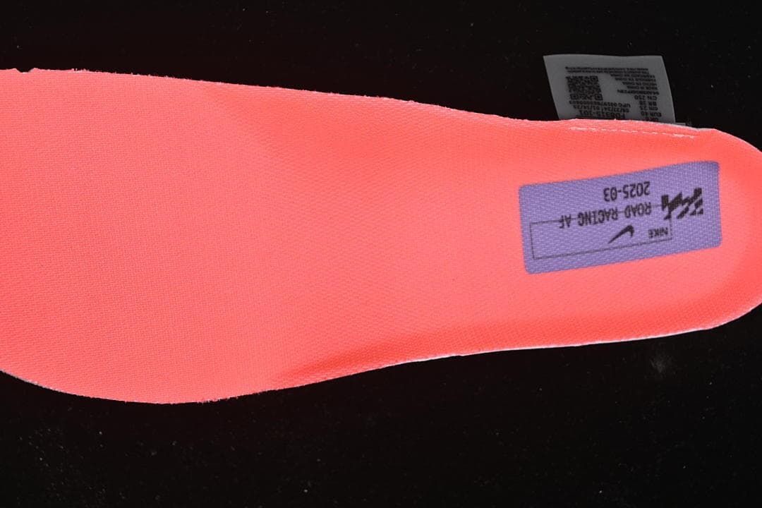 Close-up of a bright coral insole with printed graphic