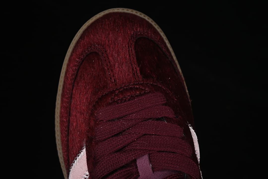 Top view of the burgundy lace-up toe and textured upper