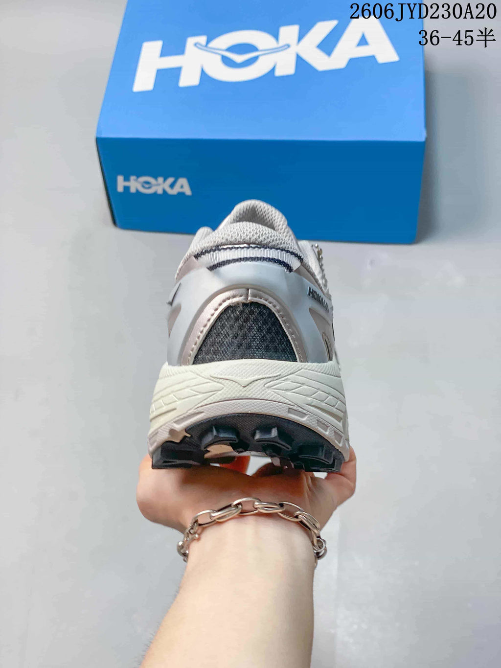 Rear view of a running shoe with a thick midsole and dark outsole