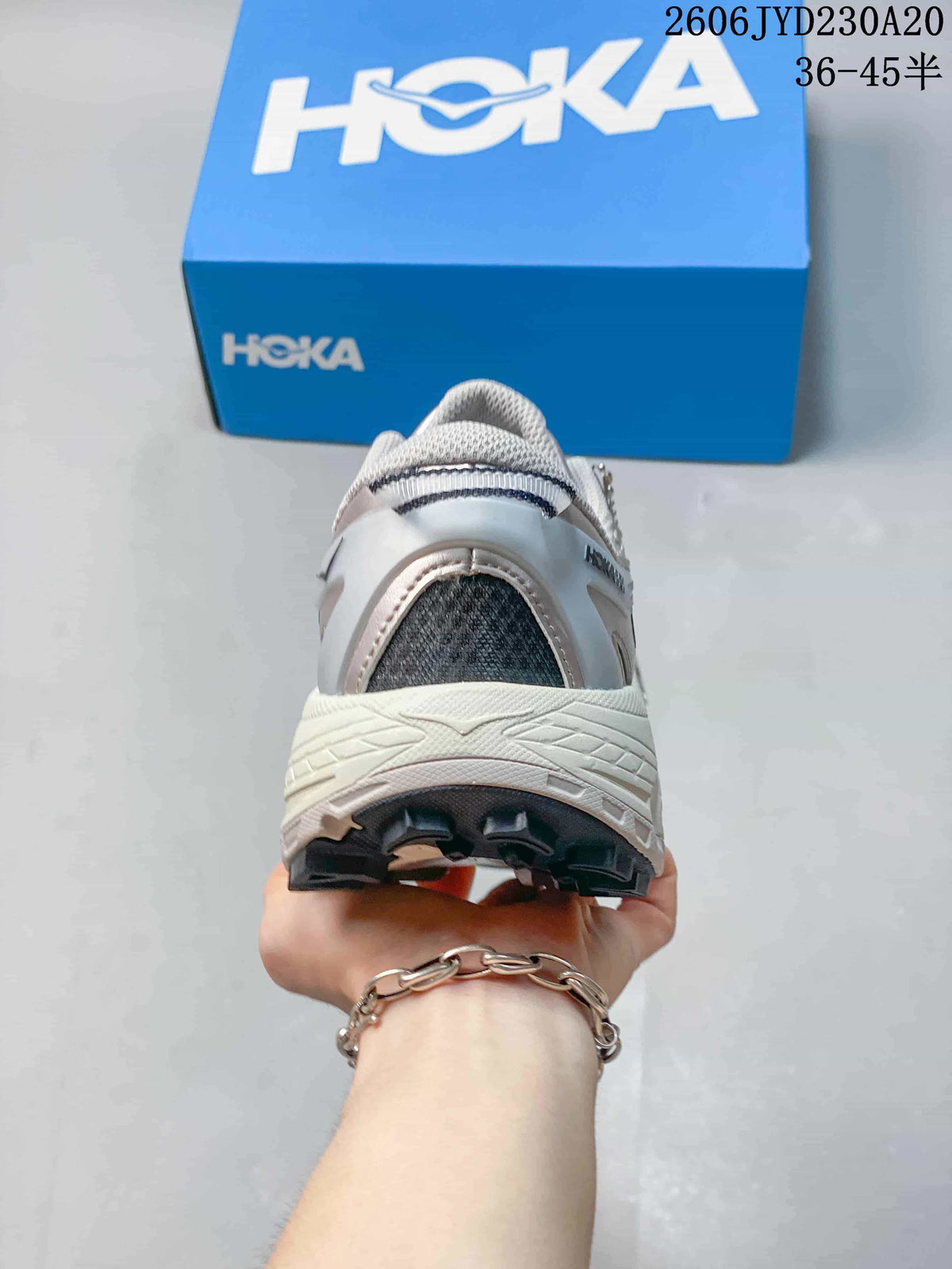 Rear view of a running shoe with a thick midsole and dark outsole