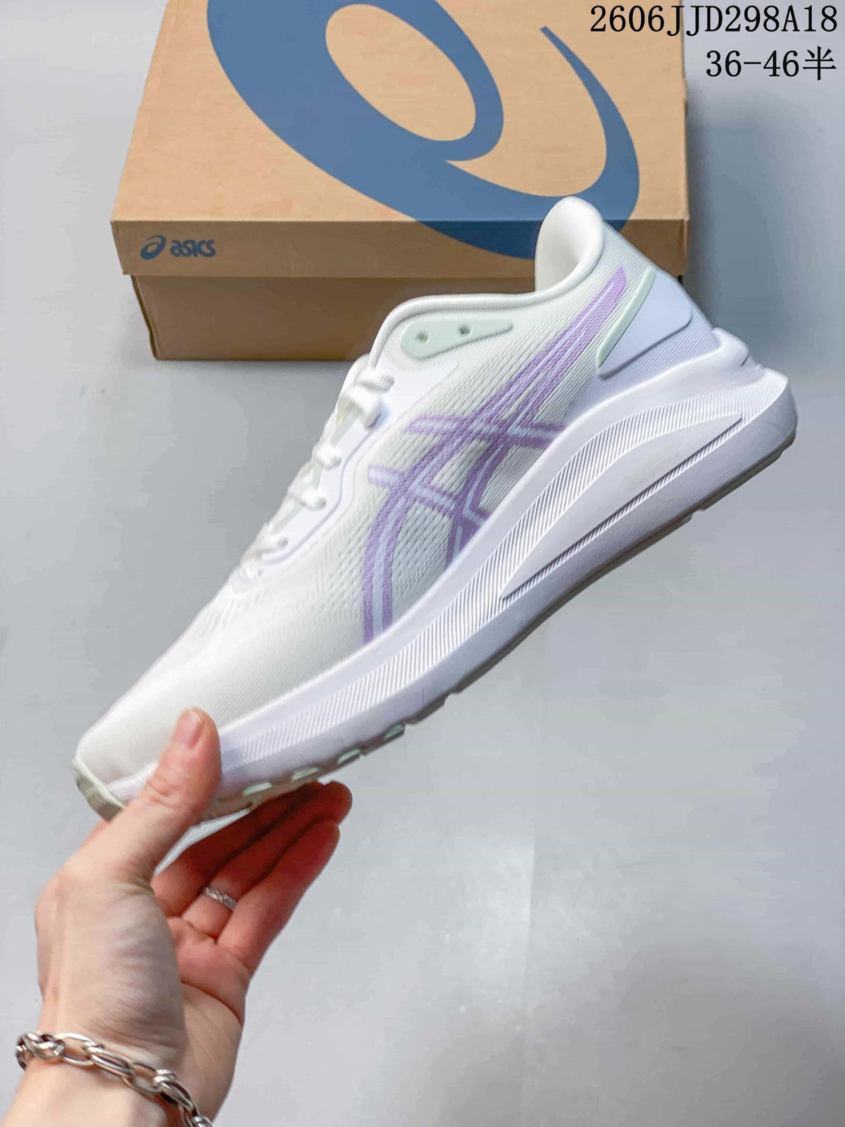 Side view of a white ASICS GT-1000 13 Paris shoe with pale purple accents