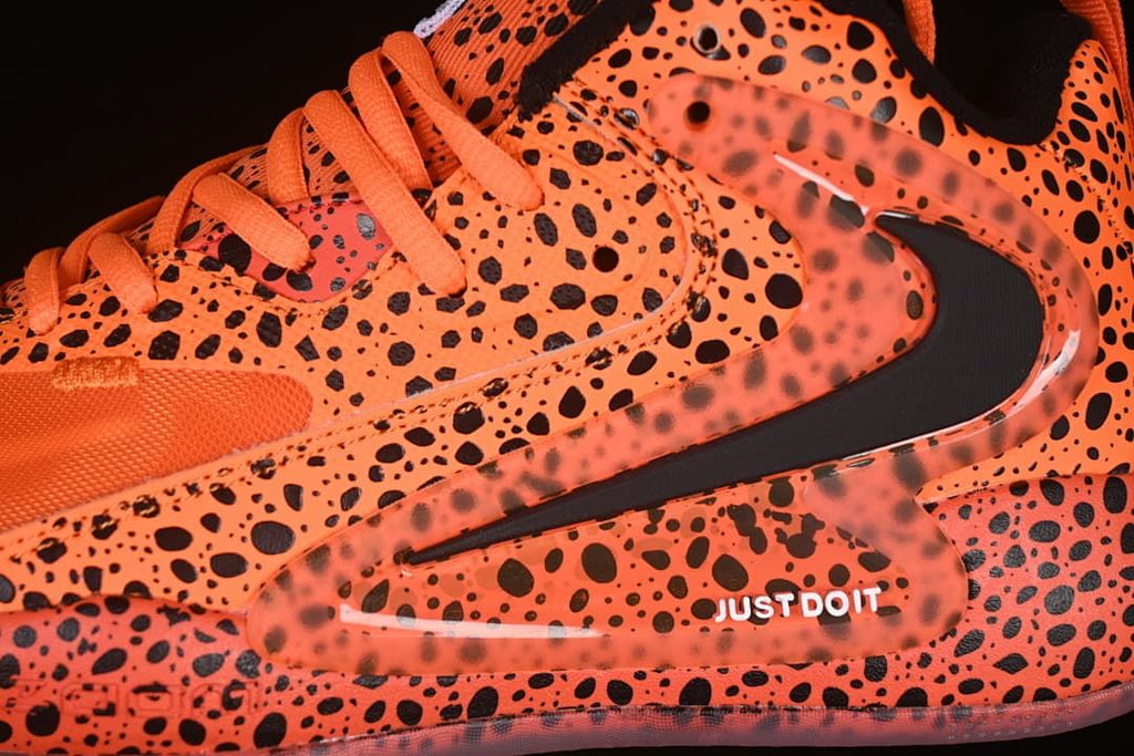 Close-up of the spotted side panel, Swoosh detail, and printed text.