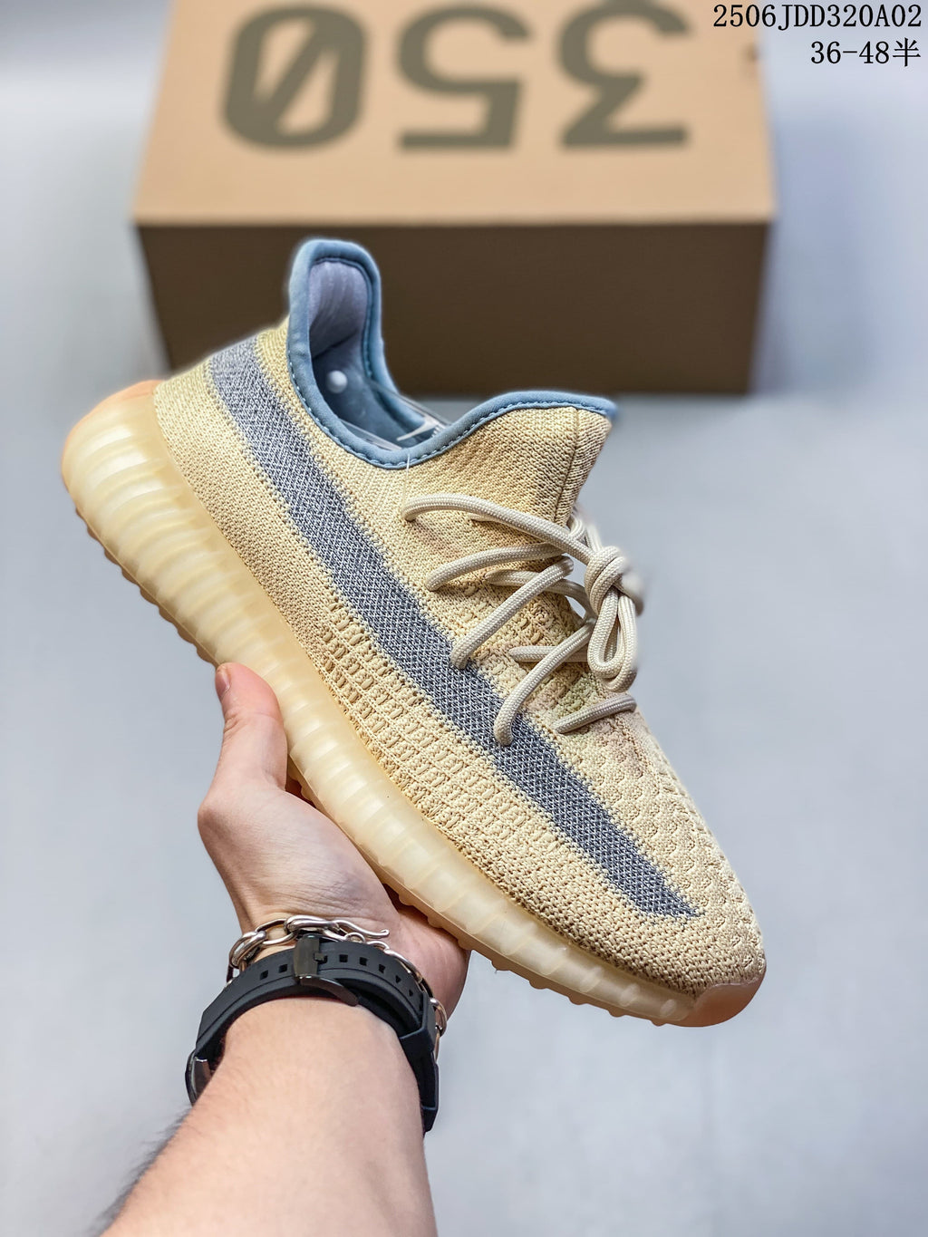 Cream Adidas Yeezy-style sneaker with a gray side stripe