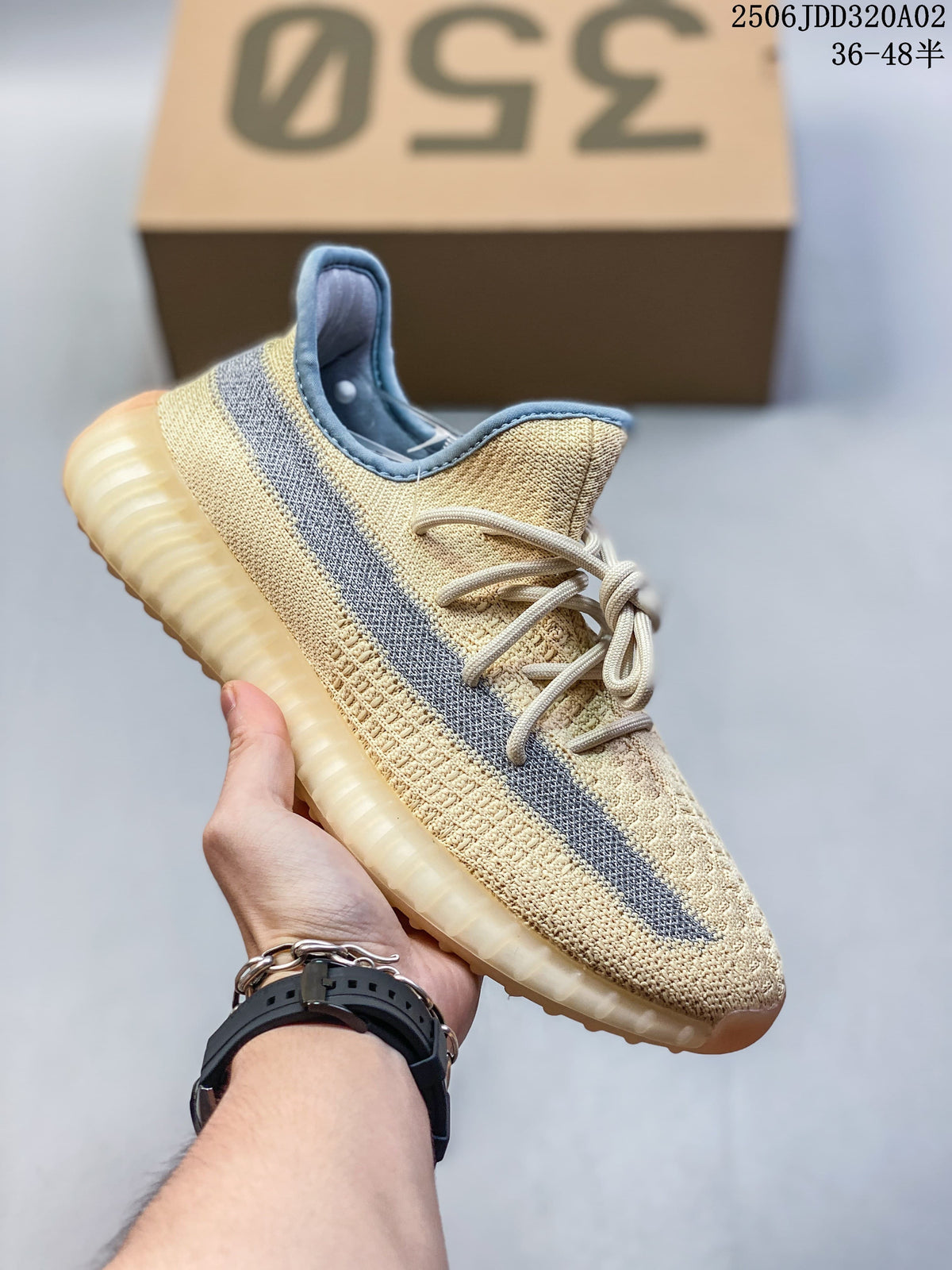 Cream Adidas Yeezy-style sneaker with a gray side stripe