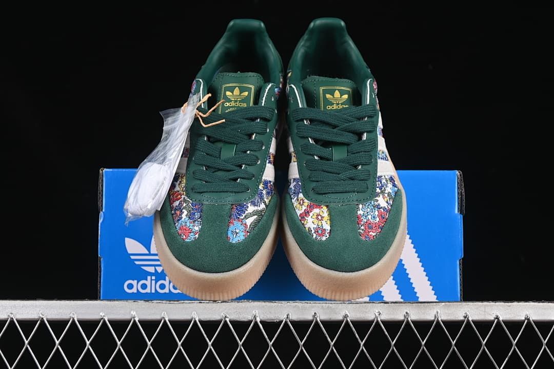 Front view of the pair showing green toes, floral-patterned panels, and gum-toned soles.