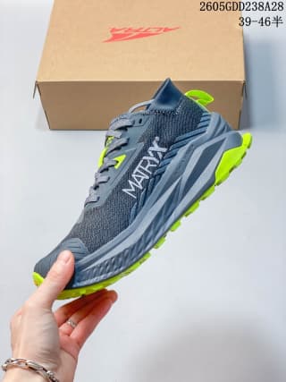 Side view showing the gray upper, sculpted midsole, and neon yellow-green outsole