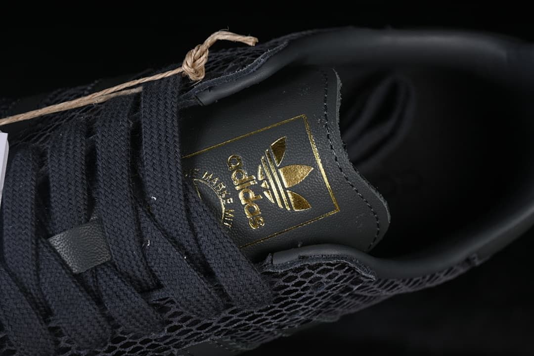 Close-up of tongue branding and dark lace-up detail