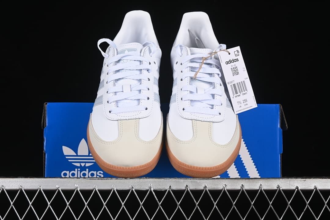 Front view of the pair showing cream toe overlays, grey stripes, and gum soles