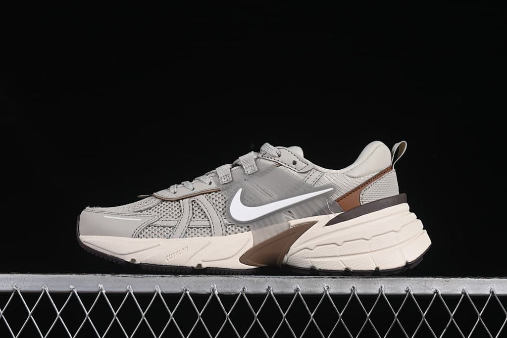 Side view of a grey and off-white Nike V2K Run sneaker
