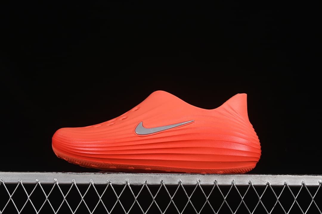 Side view of an orange Nike ReactX Rejuven8 clog sandal
