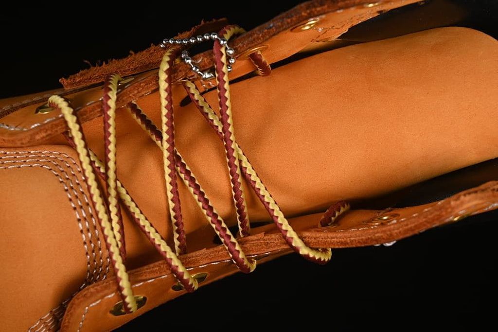 Close-up of the boot's two-tone lace pattern and open lacing panels