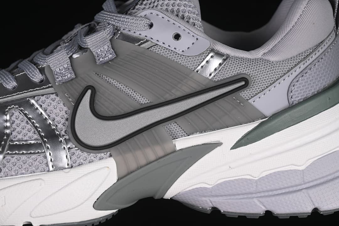 Close-up of the side Swoosh, metallic-look overlays, and mesh panels
