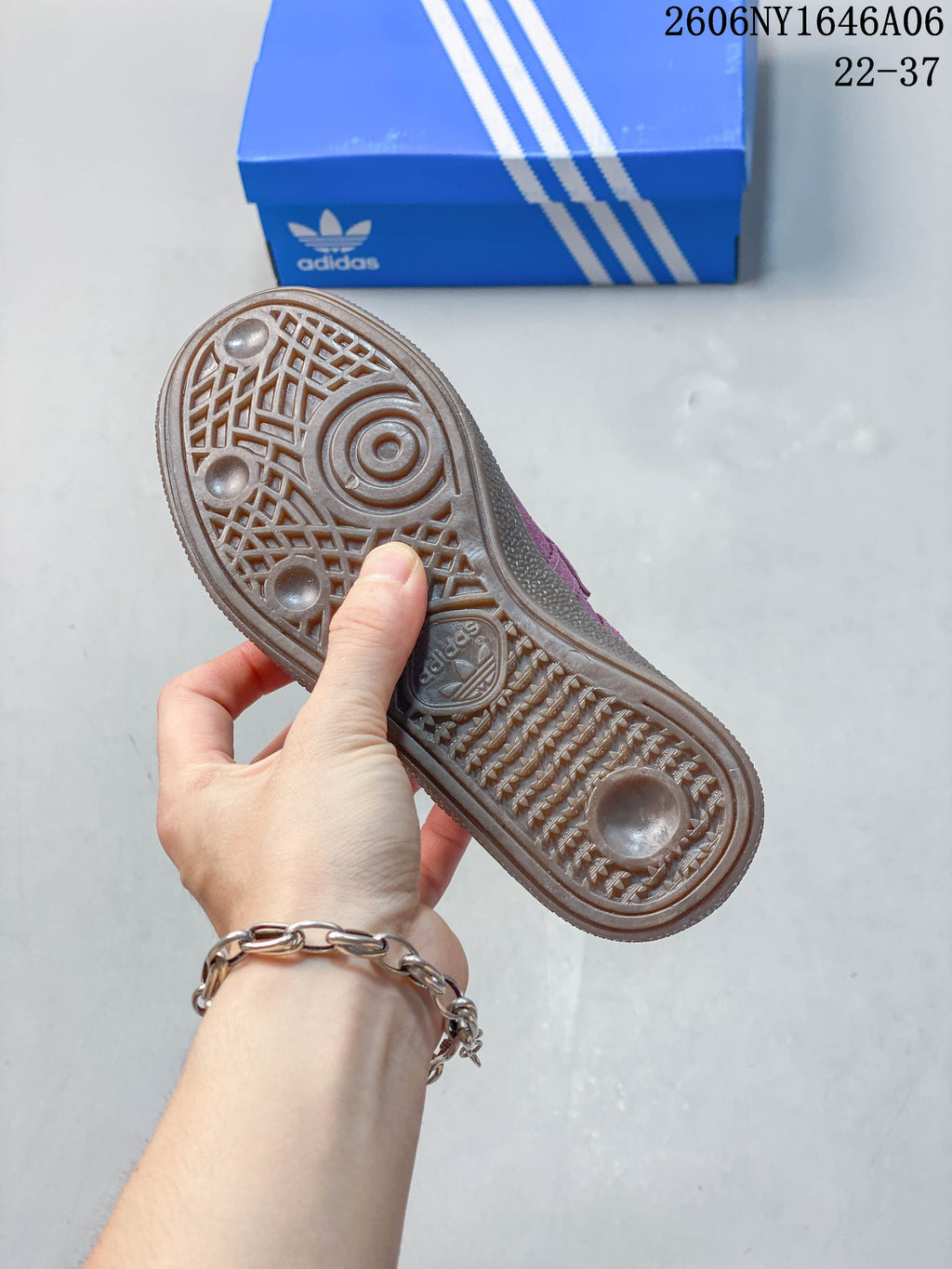 Underside view showing the textured tread of a mauve Handball Spezial sneaker