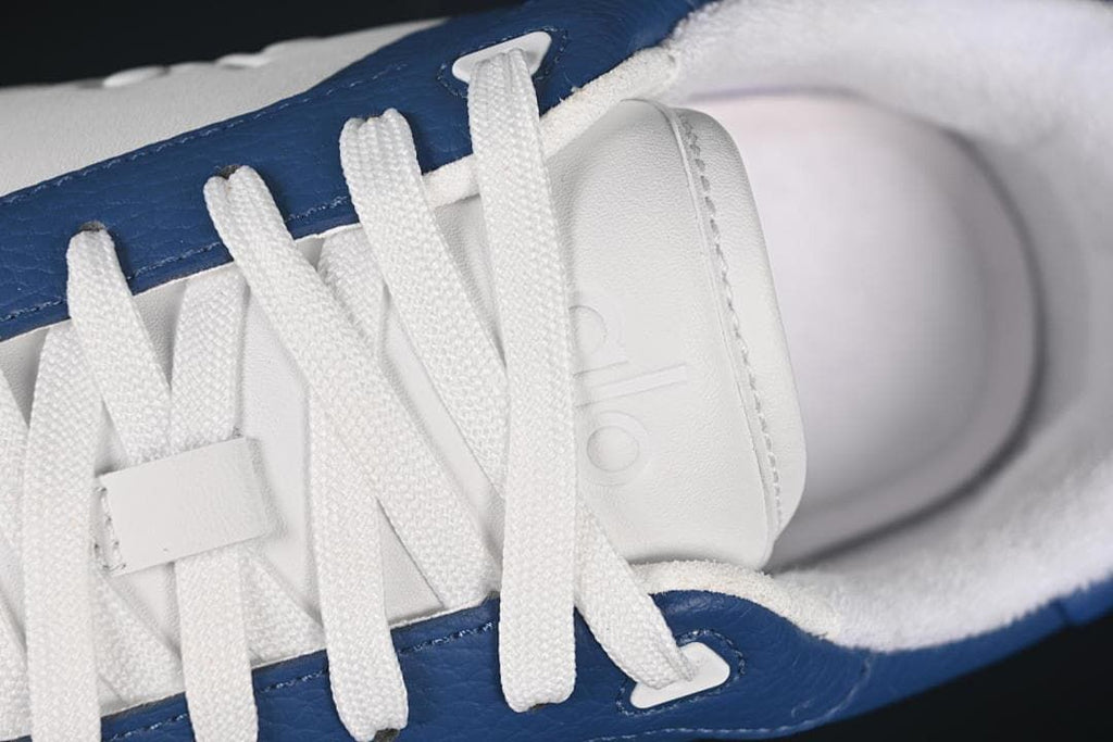 Close-up of white laces and branded tongue