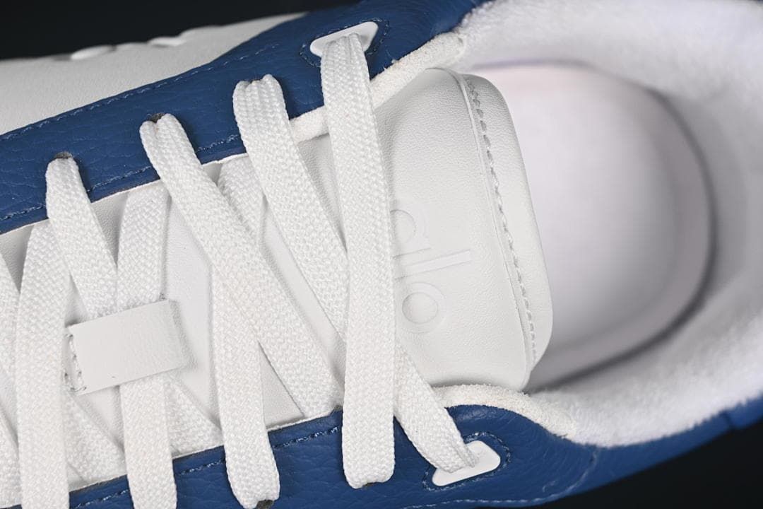 Close-up of white laces and branded tongue