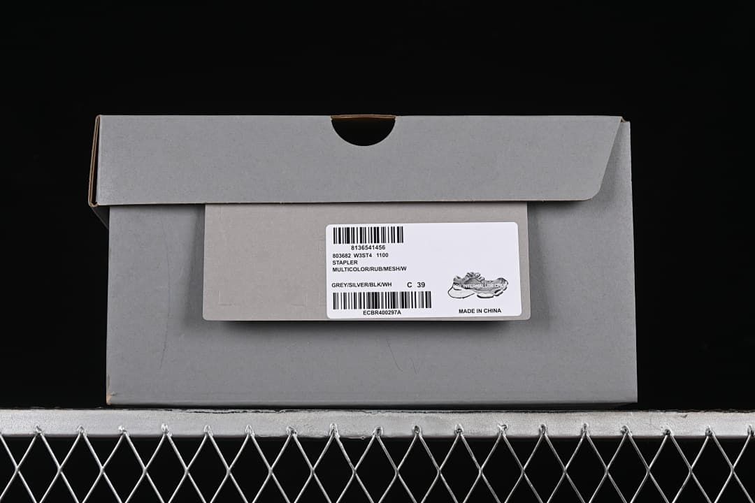 Sneaker box label showing model information, grey and silver color description and EU size 39