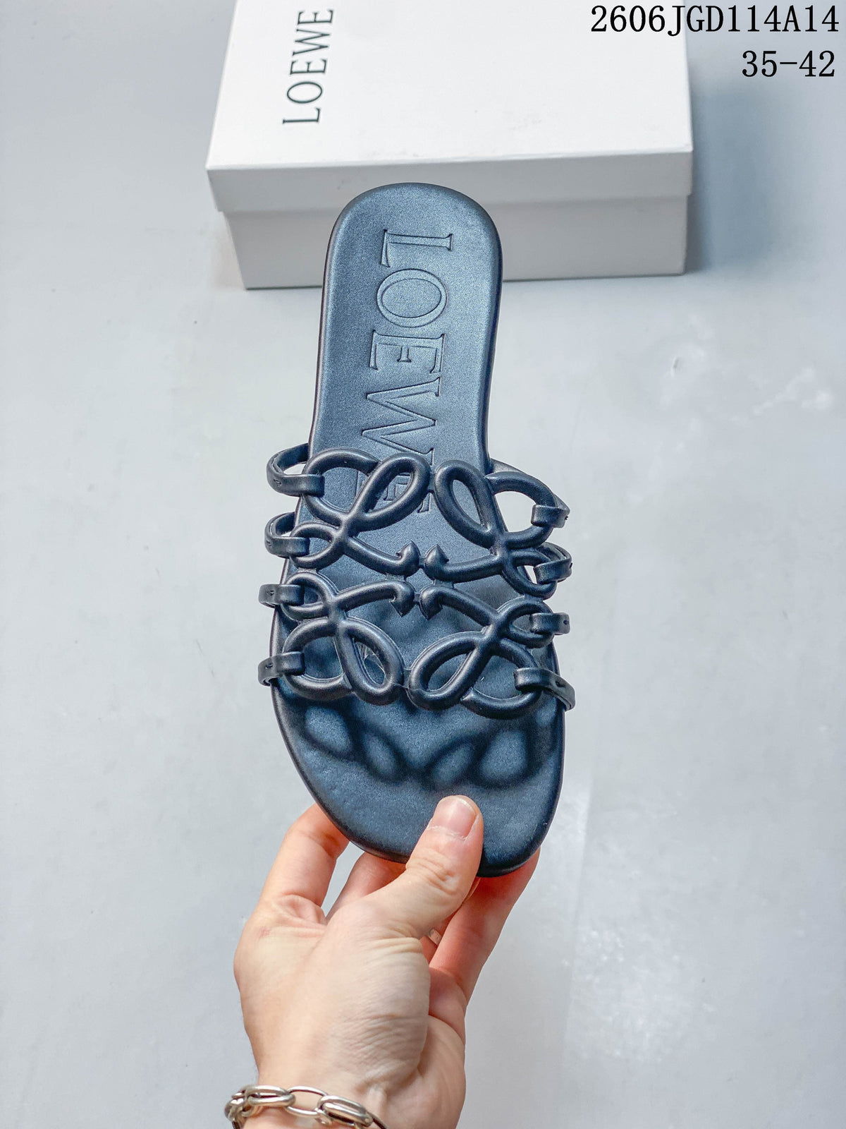 Top view of a dark navy slide sandal with a square toe, sculptural straps, and embossed footbed lettering.