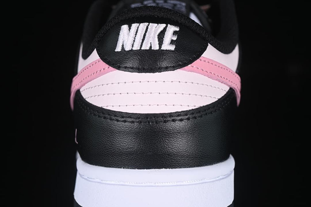 Rear view showing the black heel panel and pink and white details