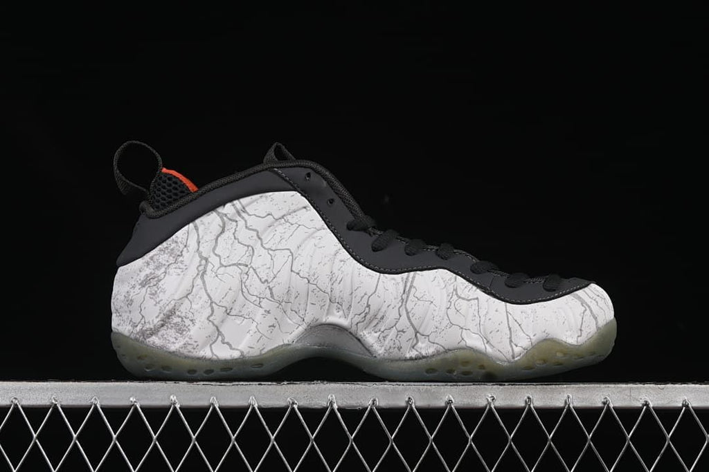 Side profile showing the patterned upper, black trim, and translucent outsole.