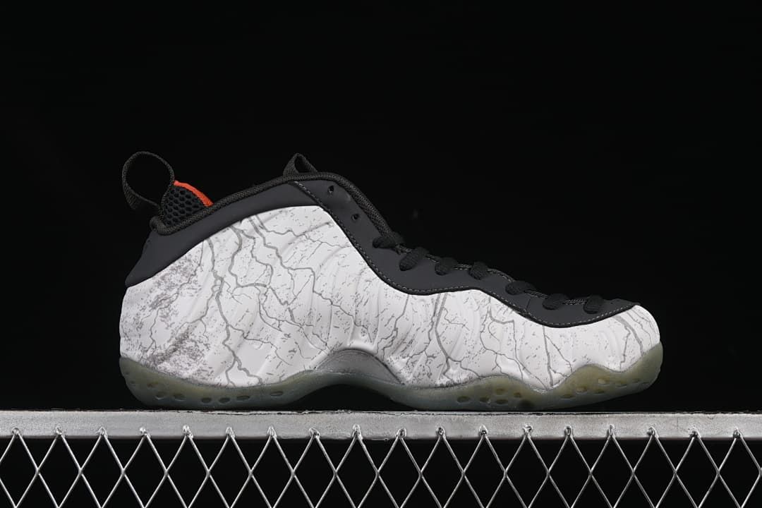 Side profile showing the patterned upper, black trim, and translucent outsole.